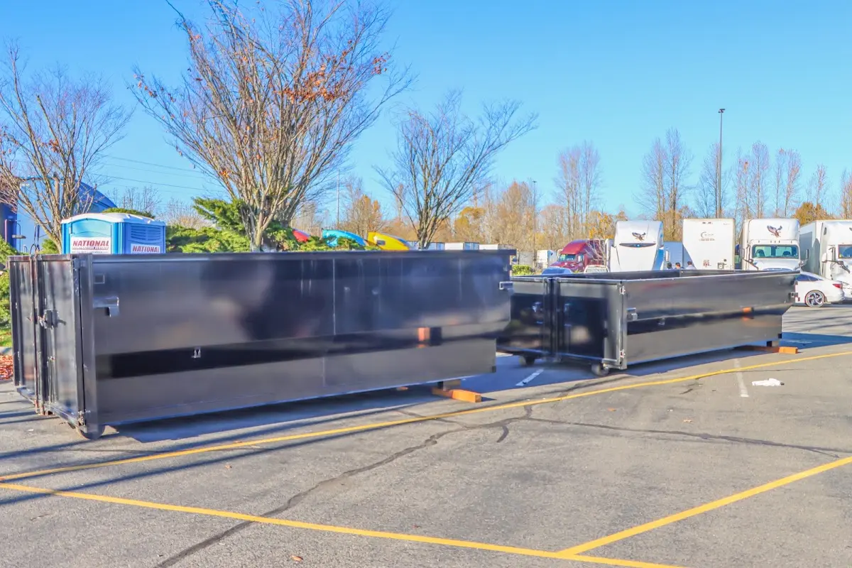 Professional dumpster rental service with roll-off container on residential driveway in Hartford